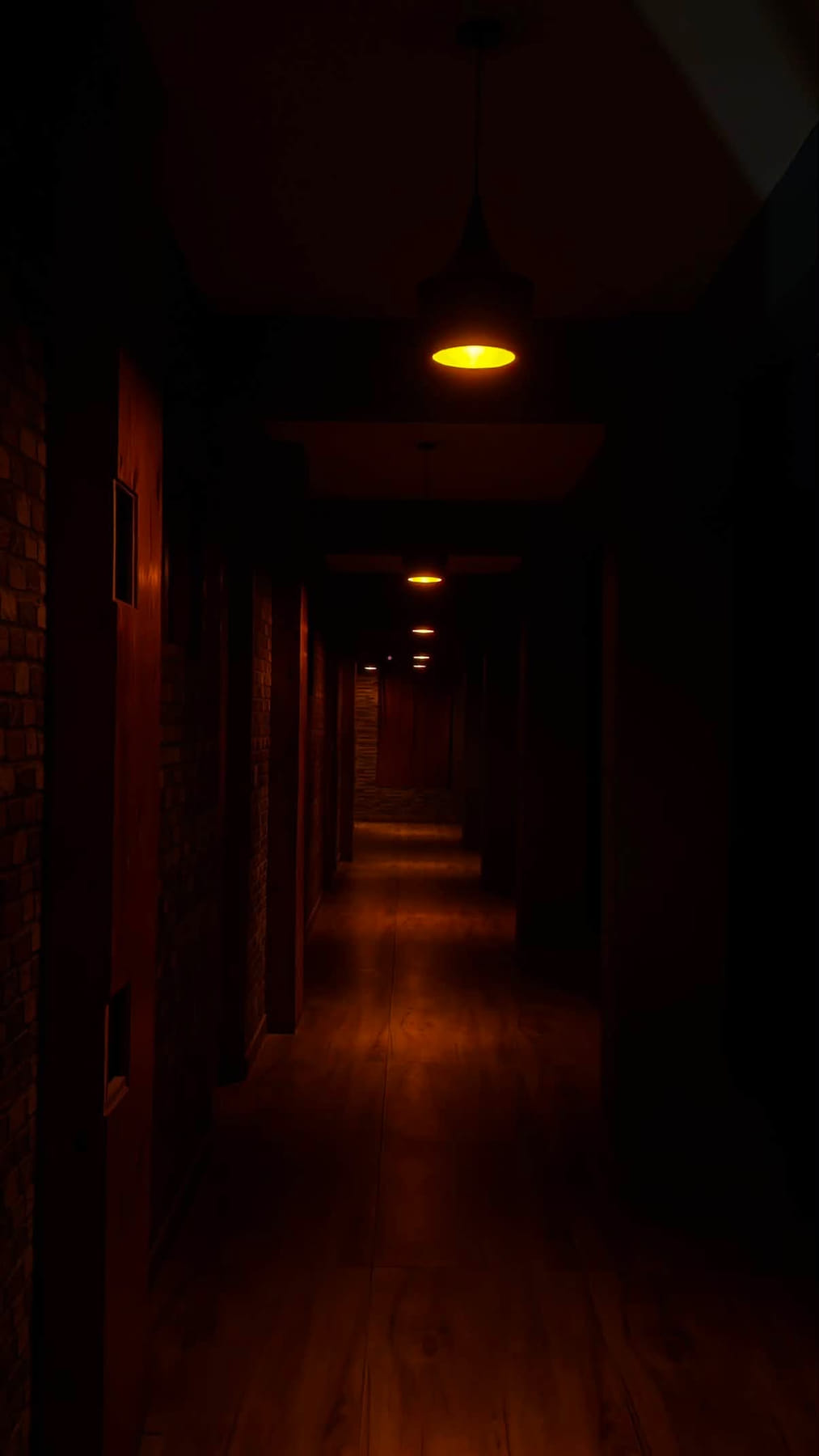 Dark timber corridor lit by a row of warm amber pendant lamps