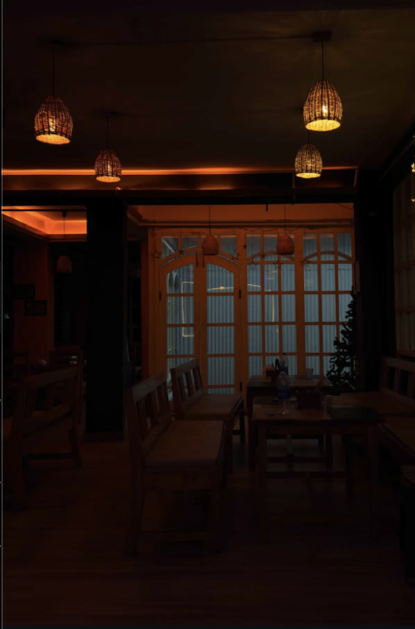 A warm, softly lit wooden interior with woven pendant lamps